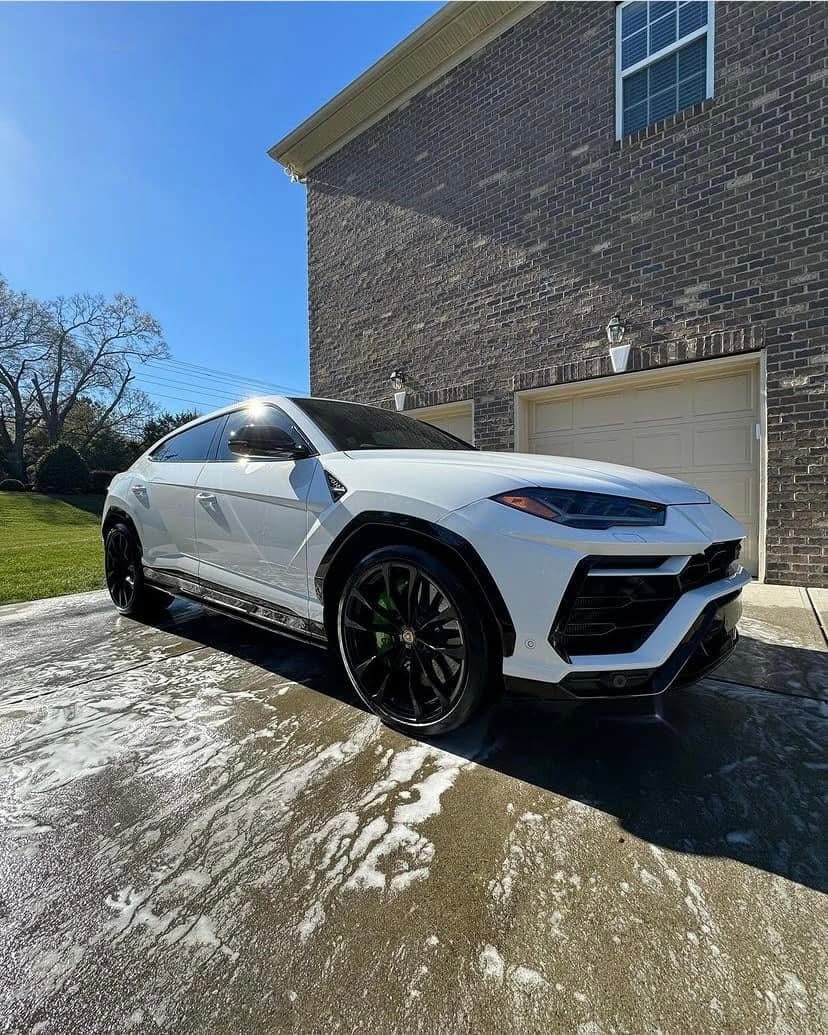 White Lamborghini Urus wash in the driveway